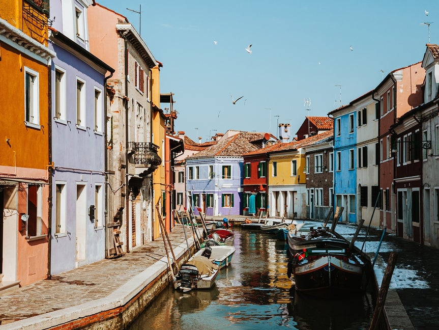 Original photo of colorful canal-side buildings and boats in natural lighting