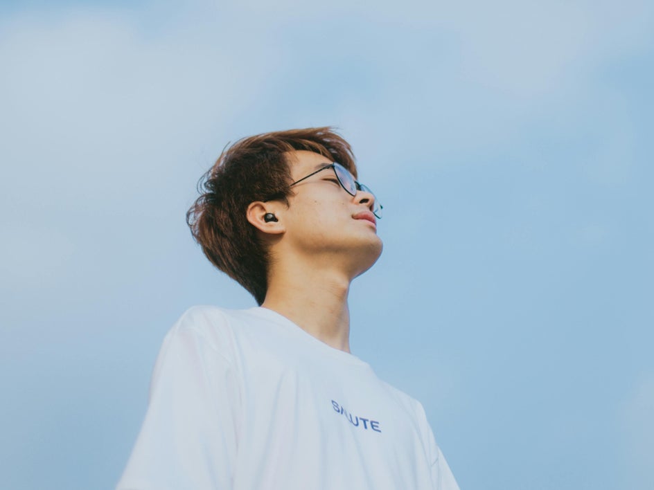 Light blue sky with social media creator advertising earbuds