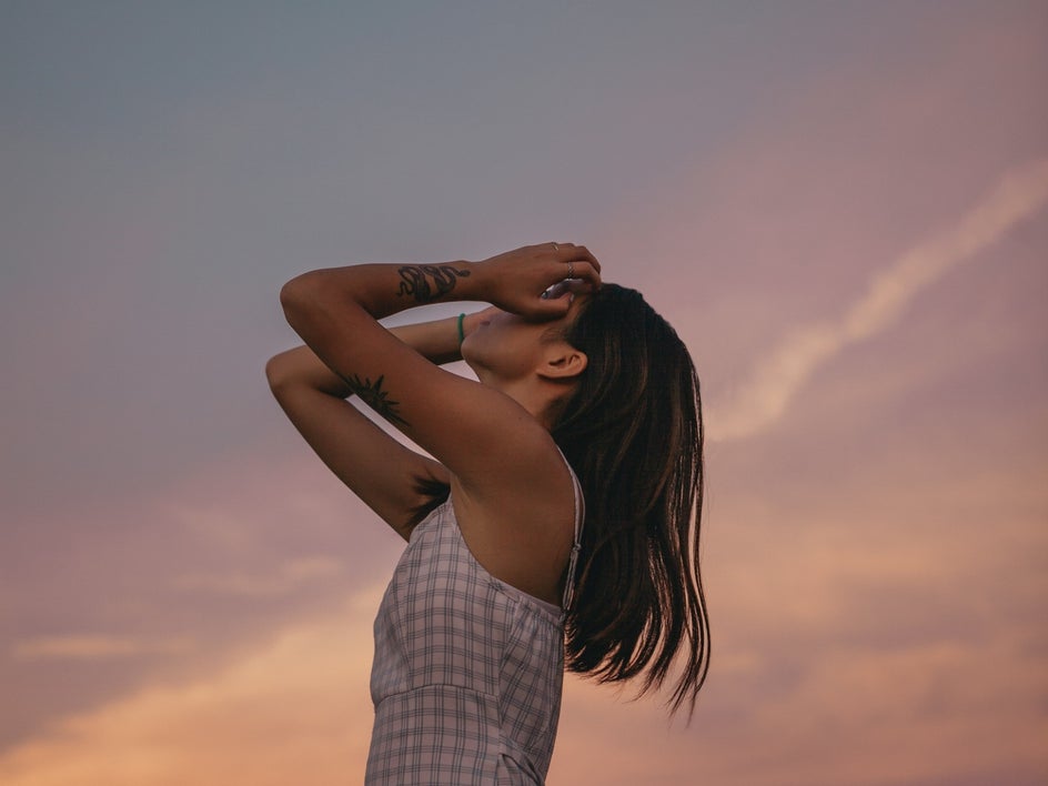 Editorial portrait at sunset of young woman