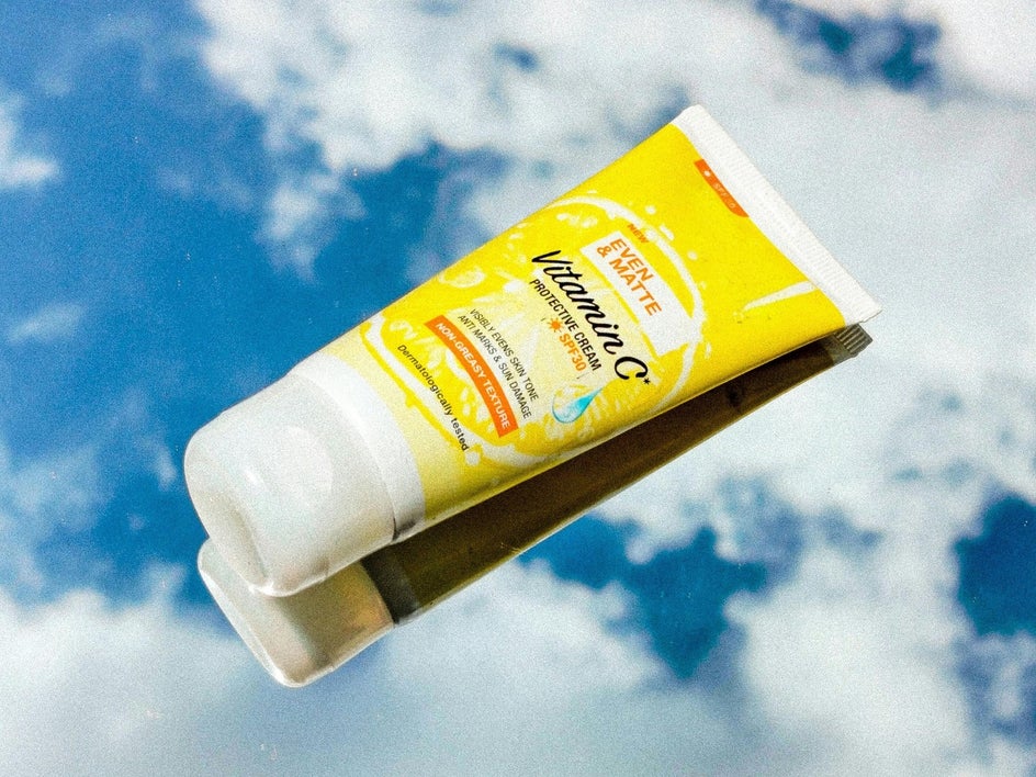 Vitamin C skincare product displayed on a flat lay with sky replacer used to brighten the sky