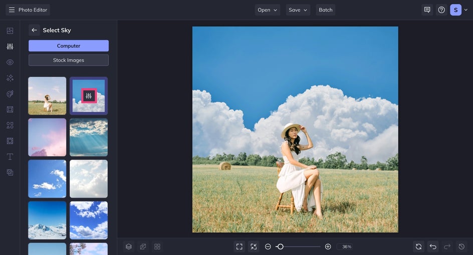 The “Select Sky” window is expanded, displaying a variety of preloaded sky thumbnails — including blue skies, cloudy scenes, and sunsets. A sky option with puffy clouds is highlighted for preview.
